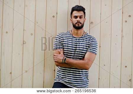 Handsome Tall Arabian Beard Man Model At Stripped Shirt Posed Outdoor Against Wooden Background. Fas