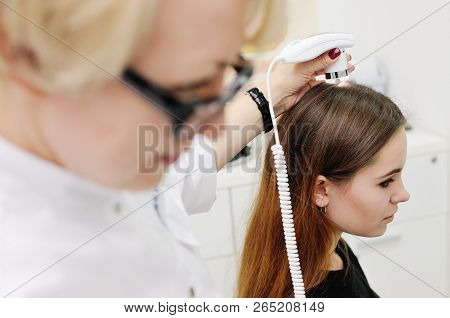 Doctor Examines The Hairy Part Of The Patient's Head
