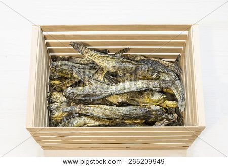 Dried Small Fish In Wooden Box On White. Beer Snack