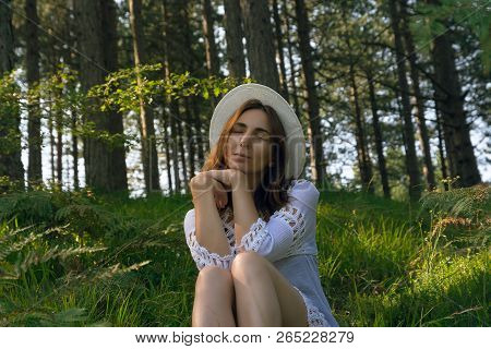 Portrait Of  Beautiful Woman Relaxing In Nature. Beautiful Woman Relaxing In Nature. Healthy Lifesty