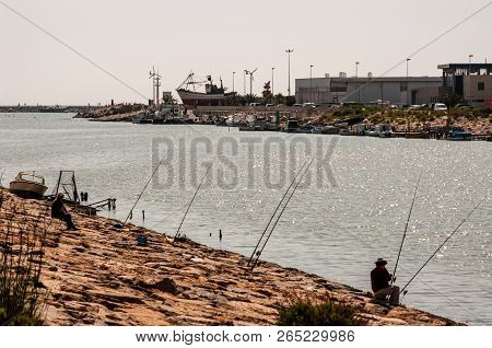 Guardamar, Spain - 12 Jun 2011 : Men Fishing On The Outlet Of The Rio Segura