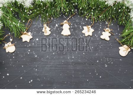 Christmas Decorations With Cookies, Fir Tree Branches And On Dark Background With Copyspace.