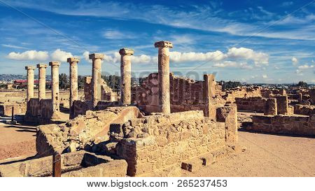 Ancient Ruins Of Kourion City Near Pathos And Limassol, Cyprus. Row Of Columns Under Blue Sky. Trave