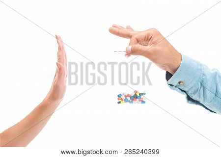 Cropped Image Of Girl Rejecting Unhealthy Drug Pills And Showing Stop Sign To Man Isolated On White