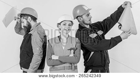 Men And Woman In Helmets Carefree With Hammer And Project