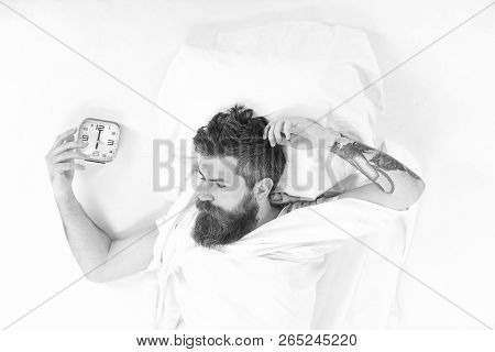 Man Already Awake Looks At Alarm Clock, Top View.