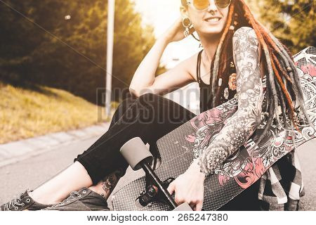 Ufa, Russia - September 12, 2018 Editorial Photo Of Young Girl With Tattoo And Dreadlocks Sitting In