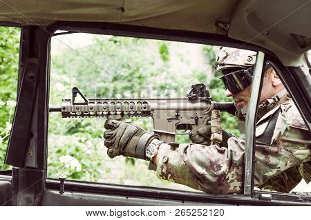 Military Man With Automatic Rifle And Rifle Scope