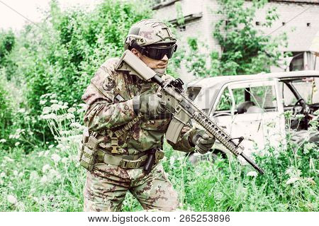 Military Man With Automatic Rifle And Rifle Scope