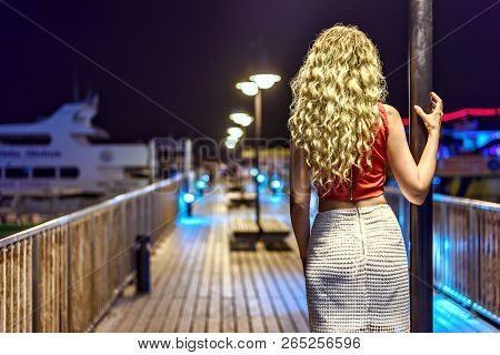 Woman Enjoying The Summer Evening Portrait From The Back. Port View Protaras, Cyprus. Yacht At The B