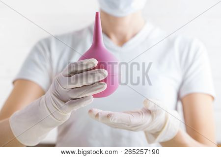 Enema In The Doctors Hand On The White
