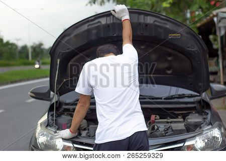 Mechanic Wearing Gloves Open Car Hood Checking Car Engine Oil While Parked On The Road After Car Bre