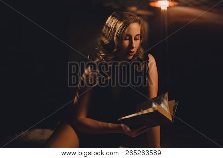 Attractive Young Woman With Long Brown Hair Sitting In Black Sexy Body On A Carpet Reading A Book Li