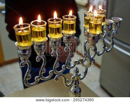 Beautiful Hanukkah Menorah Chanukkiah With Glowing Oil Candles In A Table