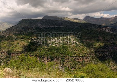 View Of The Traditional, Greek Village Kalarrytes Which Is On The Mountain Baros At An Altitude Of 1