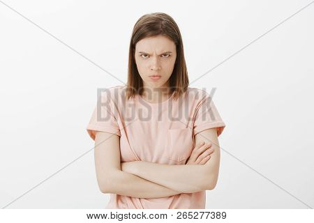 Woman Feeling Offended And Insulted, Staring From Under Forehead With Frowned Eyebrows At Camera, Su