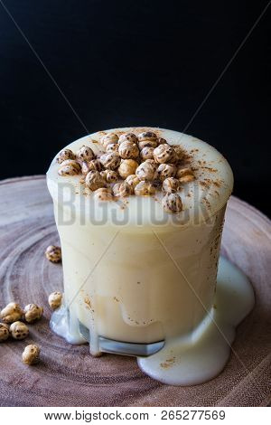 Boza Or Bosa Drink Flows From A Glass With Roasted Chickpea.