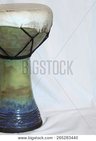 Left Side Angle Of An Of An African Doumbek Drum Against A White Backdrop