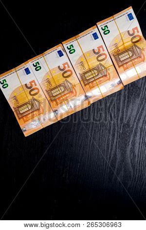 Pile Of 50 Real Euro Notes 50-euro Banknotes Under Rubber Band Isolated On Black. About 20000 Euros 