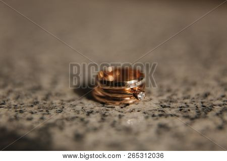 Wedding Rings On Table. Gold Rings With Diamond On Sun. Wedding Accsessories. Macro