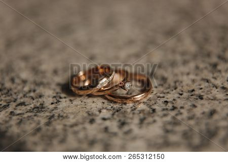 Wedding Rings On Table. Gold Rings With Diamond On Sun. Wedding Accsessories. Macro