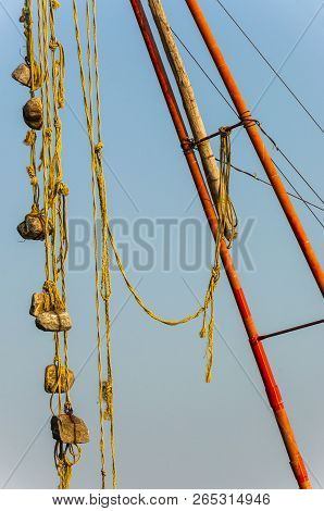 Here You Can See A Part Of Chinese Fishing Nets Mechanism - Several Stone Sinkers Tied To A Rope Han