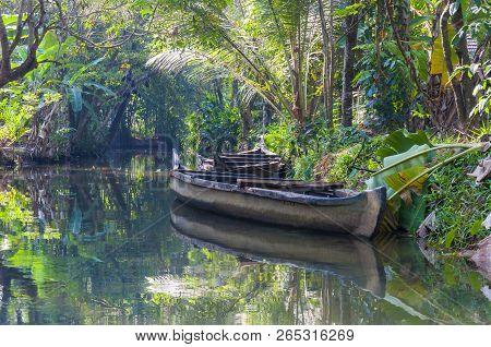 Traditional Boat Of Kerala Backwaters Moored To The Shore. Backwaters In Kerala Is A Network Of 1500