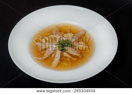 Chicken Soup In A White Plate On A Black Background