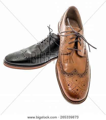 A Pair Of Mens Brown And Black Wingtip Dress Shoes On An Isolated Background