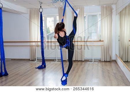 Smiling Girl Climbing On Rope Acrobatic Gymnastic Girl Exercising On Fabric Rope
