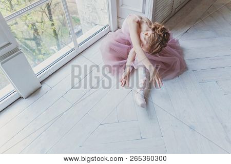 Young Classical Ballet Dancer Girl In Dance Class. Beautiful Graceful Ballerina Practice Ballet Posi