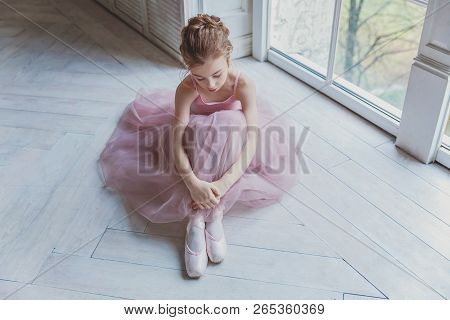 Young Classical Ballet Dancer Girl In Dance Class. Beautiful Graceful Ballerina Practice Ballet Posi