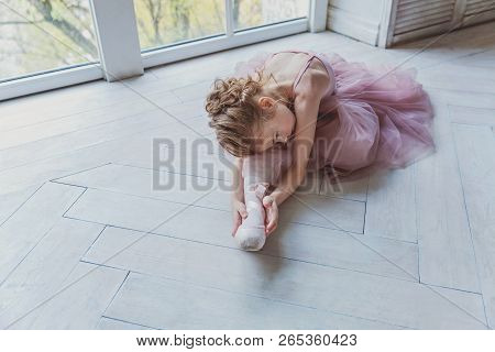 Young Classical Ballet Dancer Girl In Dance Class. Beautiful Graceful Ballerina Practice Ballet Posi