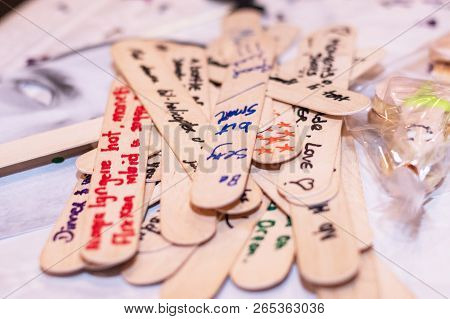 Date Night Jar Messages On Wood. Text At A Hens Party For The Bride. Horizontal. Side View. Shallow 