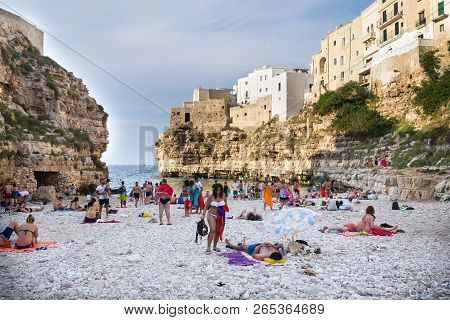 Monopoli, Italy - July 6 2018: People On Lovely Beach Lama Monachile In Polignano A Mare, Adriatic S
