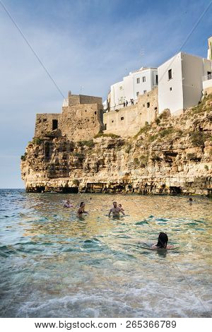 Polignano A Mare, Italy - July 6 2018: People On Lovely Beach Lama Monachile, Adriatic Sea, Apulia,