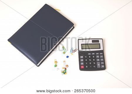 Office Accessories With Calculator And Notepad On Desk