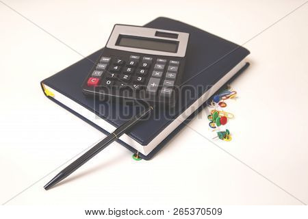 Office Accessories With Calculator And Notepad On Desk