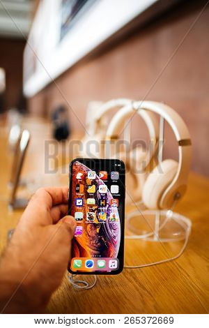 Paris, France - Oct 26, 2018: Man Hand Holding New Iphone Xs Xr Max With Apple Music App And Multipl