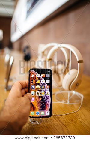 Paris, France - Oct 26, 2018: Man Hand Holding New Iphone Xs Xr Max With Apple Music App And Multipl