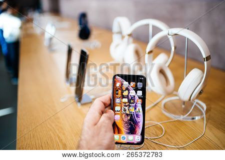 Paris, France - Oct 26, 2018: Man Hand Holding New Iphone Xs Xr Max With Apple Music App And Multipl