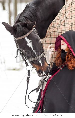 Halloween Witch With A Horse In The Snow