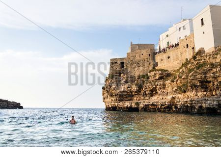 Polignano A Mare, Italy - July 6 2018: People On Lovely Beach Lama Monachile, Adriatic Sea, Apulia,