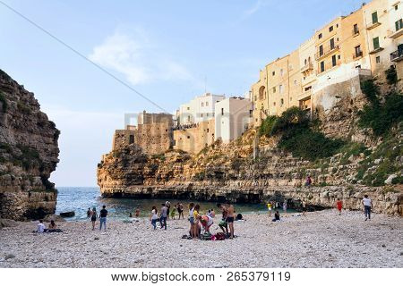 Polignano A Mare, Italy - July 6 2018: People On Lovely Beach Lama Monachile, Adriatic Sea, Apulia,