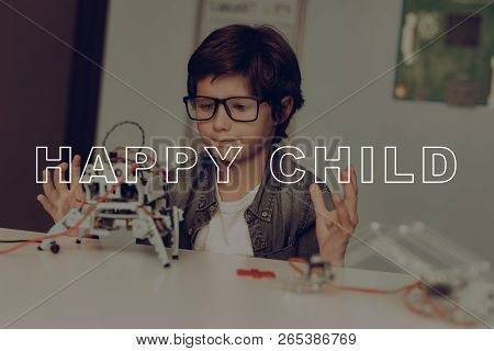 Smart Little Kid In Glasses Is Creating A Robot. Plaid Flannel. Home Leisure. Child Holiday Activity