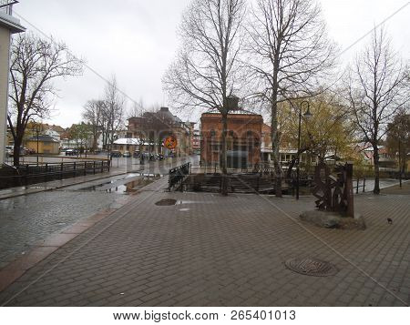 A Empty Square With A Bridge In Norrtälje. The Street Is Wet From Rain, Also A Bridge Over The Small