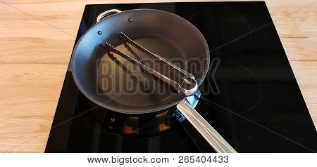 Pan On Modern Black Induction Stove, Stove, Hob With Ceramic Plate In Dark Kitchen Interior