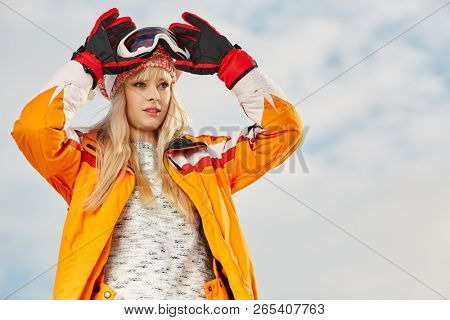 Picture of happy young lady snowboarder 