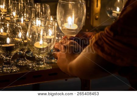 Songkhla, Thailand - July 27, 2018 : Buddhist Monk Hands Holding Candle Glass In The Dark  At Wat Ph