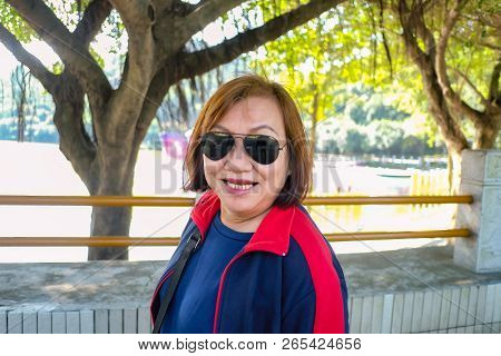 Senior Women Tourist Stand Beside The Lake On Top Of The Xiqiao Mountain Foshan City China